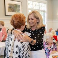Vonnie Herrera offering hug to woman attending event